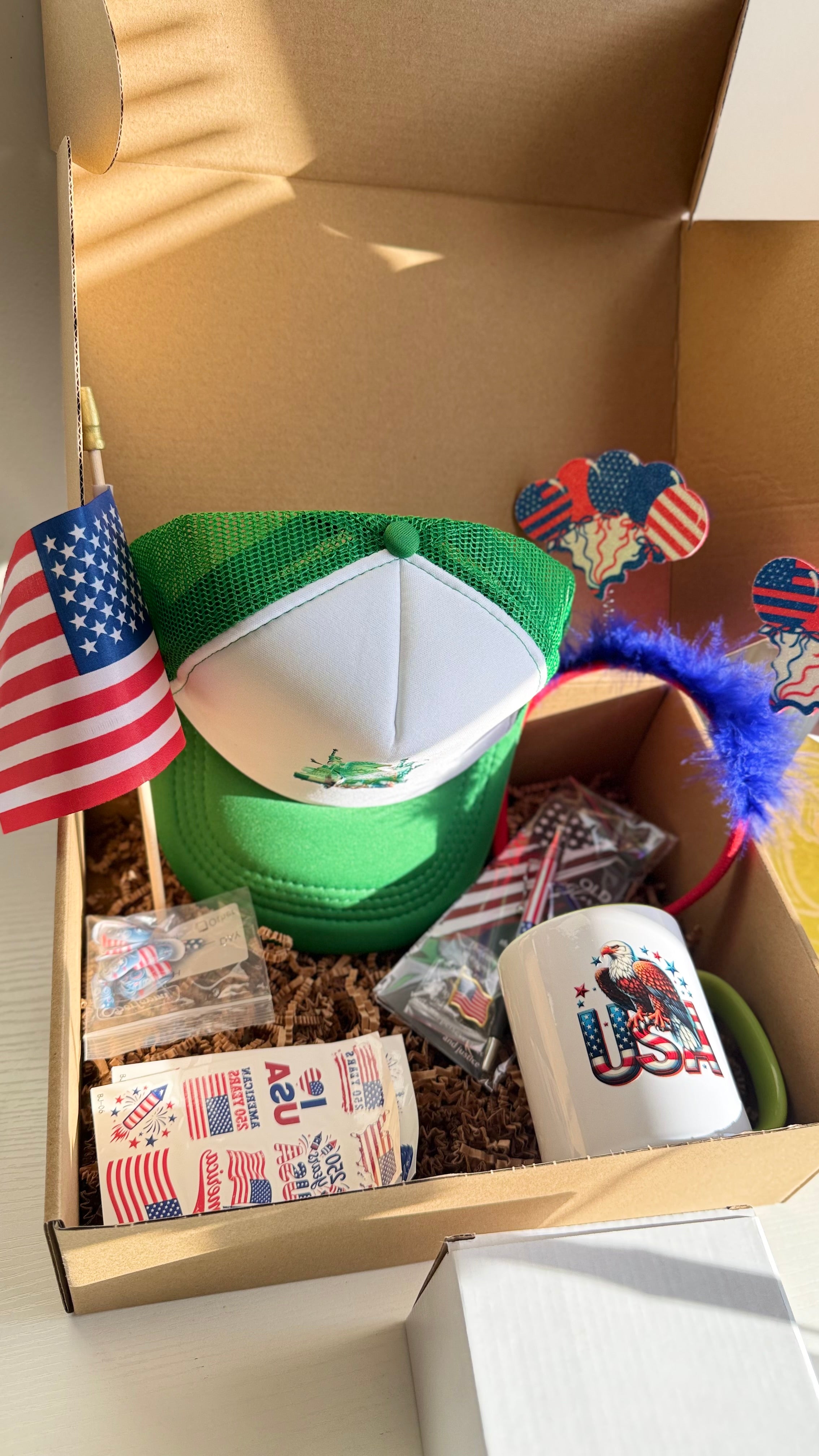 Patriotic USA Gift Set – Mug, Trucker Hat, American Flag, Press-On Nails, Pen, Stickers & Headband | 4th of July Gift Box